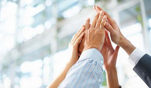 Group high-five between professionals